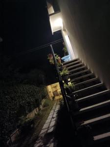 a stairway with a light on the side of a building at night at Il Giramondo in Montelabbate