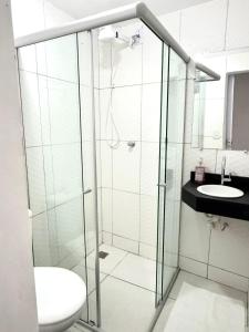 a bathroom with a shower and a toilet and a sink at A casa roxinha in Lençóis