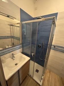 a bathroom with a sink and a glass shower at Attico Galilei Fronte Mare by Salentoville Gallipoli in Gallipoli