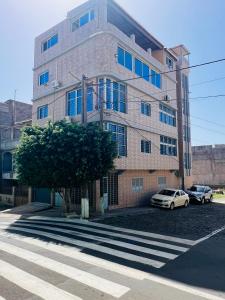a building with cars parked in front of it at Zeyden Place Apt in Praia
