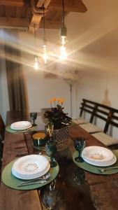 a wooden table with plates on top of it at Holiday home Vukovoj in Klenovnik +20 photos