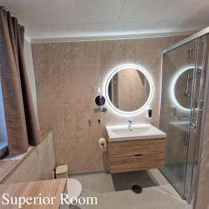 a bathroom with a sink and a shower with a mirror at Lofoten Basecamp in Leknes