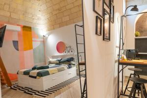 a bedroom with a bunk bed and a desk at Loft Rooms Suite B&B in Santeramo in Colle