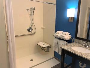 a bathroom with a shower and a sink at SureStay by Best Western Cambridge in Cambridge +11 photos