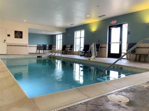 a swimming pool with blue water in a building at SureStay by Best Western Cambridge in Cambridge