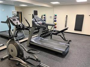 a gym with three treadmills and exercise bikes at SureStay by Best Western Cambridge in Cambridge