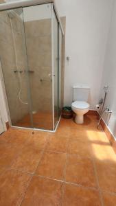 a bathroom with a toilet and a glass shower at Quinta das Águas Hotel in Itapira