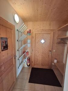 a hallway with a wooden door in a house at Chalet Martina in Stadl an der Mur