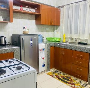 a kitchen with a stove and a refrigerator at Pendeza homes in Naivasha