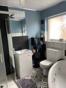 a bathroom with a white toilet and a sink at Cosy 3-bed Terrace Home, Nantwich in Nantwich