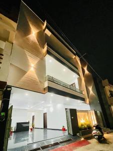 a building with a balcony with lights on it at HOTEL GLORY IN Chatha meel,raitha road lucknow in Bhauli