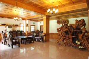 a dining room with a large wooden table and chairs at Seasons Inn in Jiaoxi