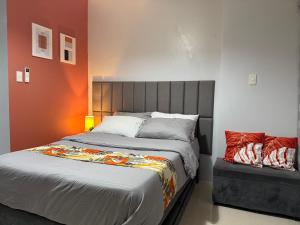 a bedroom with a large bed and a chair at RGM PLACE in Davao City +19 photos