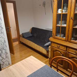 a living room with a couch and a cabinet at Apartman Anita in Varaždin