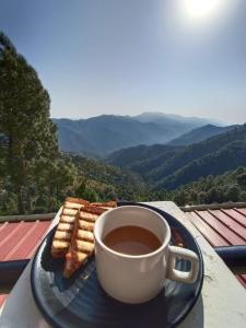 a plate with a cup of coffee and cookies on a table at Suncrest Trails Resort in Lansdowne
