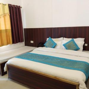 a bedroom with a large bed with blue pillows at Suncrest Trails Resort in Lansdowne