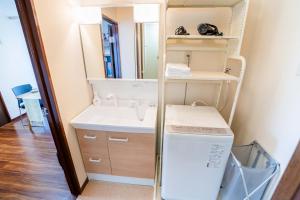 a bathroom with a sink and a washer and dryer at 202 Room, a 6-minute walk from Tokyo Koiwa Station Direct connected to Shinjuku and Akihabara Stations Comfortable one-bedroom apartment with separate wet and dry areas in Tokyo +36 photos