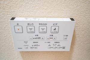 a white box with writing on the side of a wall at 202 Room, a 6-minute walk from Tokyo Koiwa Station Direct connected to Shinjuku and Akihabara Stations Comfortable one-bedroom apartment with separate wet and dry areas in Tokyo