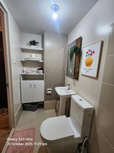 a small bathroom with a toilet and a sink at Luna's Place in Sampong