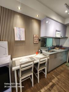 a kitchen with a table and chairs and a sink at Luna's Place in Sampong