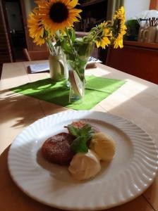 a white plate with some food on a table at Hotel Gasthaus Aujäger in Egling