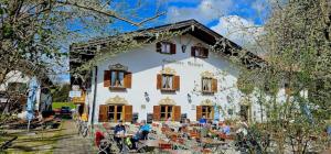 a group of people sitting outside of a building at Hotel Gasthaus Aujäger in Egling