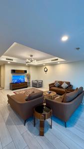 a large living room with couches and a tv at Centaurus Three Bed Mountain View in Islamabad