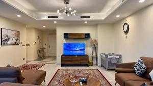a living room with a large flat screen tv at Centaurus Three Bed Mountain View in Islamabad