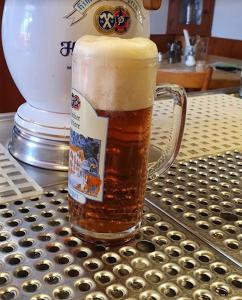 a glass of beer sitting on top of a table at Hotel Gasthaus Aujäger in Egling +37 photos