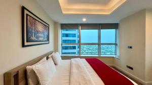 a bedroom with a bed with a large window at Centaurus Three Bed Mountain View in Islamabad