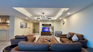 a large living room with couches and a tv at Centaurus Two Bed Mountain View in Islamabad