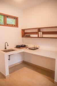 a kitchen with a sink and a counter top at Masaya Retreat Lombok in Kuta Lombok