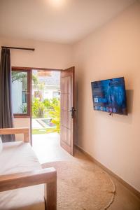 a bedroom with a bed and a sliding glass door at Masaya Retreat Lombok in Kuta Lombok +74 photos