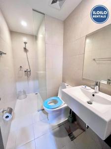 a bathroom with a toilet and a sink at Live in style Studio at Saint Dominique in Mandurriao