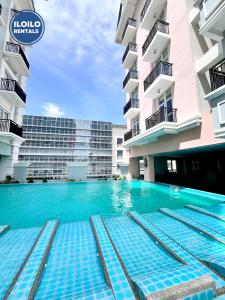 a swimming pool in front of a building at Live in style Studio at Saint Dominique in Mandurriao +10 photos