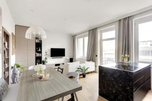 a living room with a table and a dining room at Apartment 67 in Rove