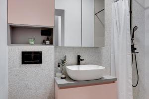 a bathroom with a white sink and a shower at Apartment 67 in Rove