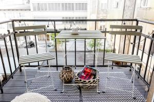 a balcony with two chairs and a table with a book at Apartment 67 in Rove