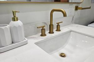 a sink with two faucets on a white counter at Luxury Family House 3 beds, 1 bath, 5 guest in Toronto +57 photos