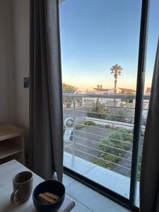 a room with a balcony with a view of the ocean at 6 on Third in Stompneusbaai