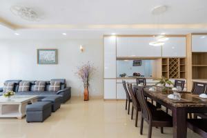 a living room and dining room with a couch and a table at Oasky Vũng Tàu - AnNam's Home in Vung Tau