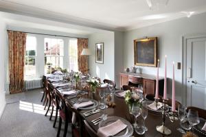 a long dining room with a long table and chairs at Butley Priory Farmhouse in Woodbridge +58 photos