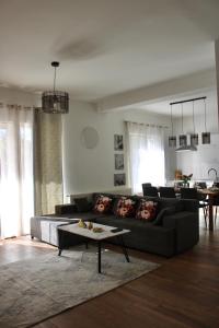 a living room with a couch and a table at Villa La Plazza in Dugopolje