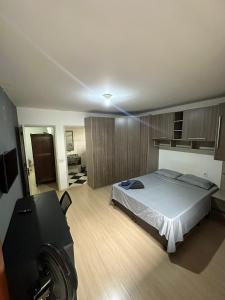 a bedroom with a bed and a camera in it at Quartos Vila Olímpia 1 in Sao Paulo