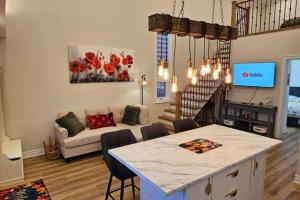 a kitchen and living room with a table and a couch at Luxury Family House 3 beds, 1 bath, 5 guest in Toronto