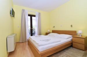 a bedroom with a bed with white sheets and a window at Villa Maravilla in Jadranovo +41 photos
