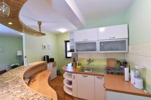 a kitchen with white cabinets and a counter top at Villa Maravilla in Jadranovo