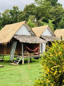 a group of huts with people sitting in them at Sparrow Hut in Pai +32 photos