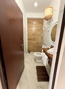 a bathroom with a toilet and a sink at Aman Nest in Jāmb