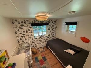 a bedroom with a black bed in a room at Beautiful and private with heated pool & hot tub in Ljungbyhed